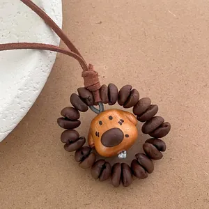Detailed view of hand-carved peach wood puppy pendant with coffee bean decorative beads