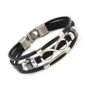 Detail of multi-layer black leather bracelet with infinity symbol and metal clasp