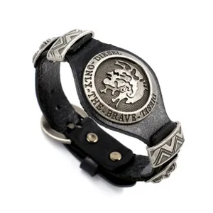 Close-up of black braided leather bracelet featuring vintage metal buckle and iconic logo