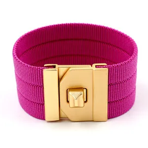 Close-up of rose red woven wide cuff bracelet with gold matte metal buckle detail