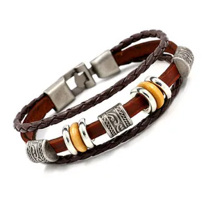 Close-up of layered leather bracelet featuring braided ropes and retro silver metal clasp