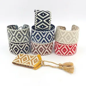 Close-up of woven cotton bracelets featuring bohemian geometric patterns and tassels