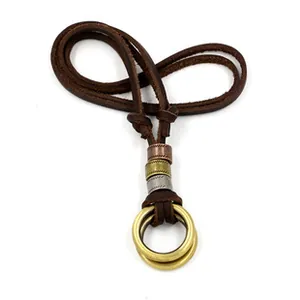 Detail view of brown multi-layer leather cord necklace with metallic tube accents