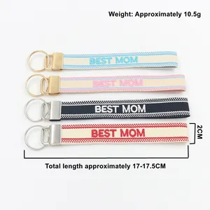 Detail view of ethnic embroidered BEST MOM wrist straps with gold and silver keyrings
