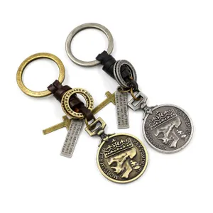 Macro view of vintage bronze maple leaf leather keychain with cross and skull charms