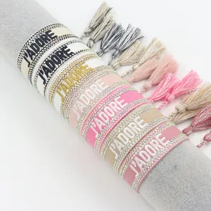 Detailed view of J'ADORE embroidered ethnic bracelets with tassels and rhinestone trim