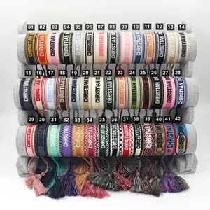 Detailed grid showing woven fabric bracelets with colorful strawberry embroidery and tassels