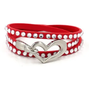 Detail of red multilayer PU leather bracelet with sparkly rhinestones and heart clasp