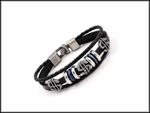 Detail showing woven leather bracelet with vintage dollar sign charms and metal buckle