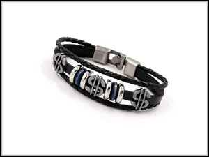 Detail view of multi-layer black leather bracelet with silver dollar sign charms and rings