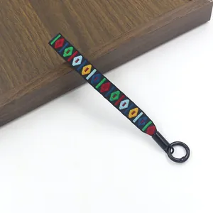 Detail van de etnisch geborduurde polsband met kleurrijke geometrische patronen
