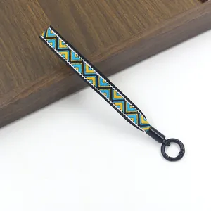 Detail van een handgeweven etnisch koord met geometrische patronen en metalen sluiting