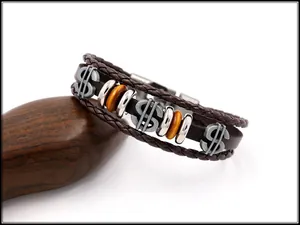 Close-up of vintage multi-layer braided leather bracelet with metal dollar sign charms