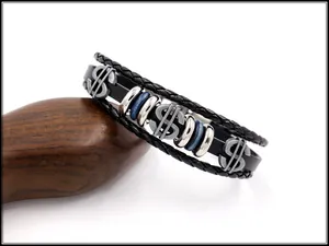 Detail of multi-layer braided leather bracelet with silver dollar sign and blue beads