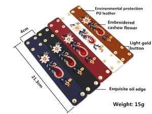 Détail de manchettes en cuir PU avec broderie paisley et boutons-pression dorés