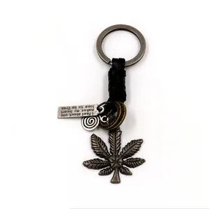 Vintage alloy maple leaf keychain with braided leather rope and engraved metal tags
