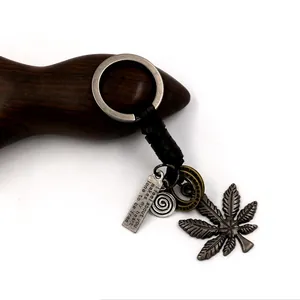 Vintage alloy maple leaf leather keychain with engraved tag and braided rope detailing