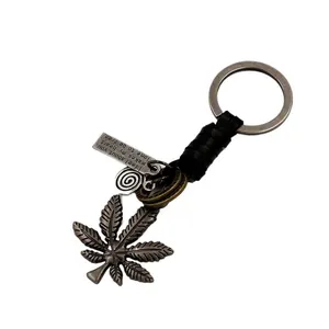 Vintage braided leather keychain featuring bronze maple leaf and engraved metal tag