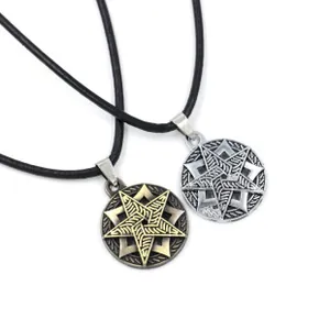 Close-up of vintage bronze and silver pentagram pendants on black leather cords
