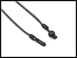 Close-up of black braided rope and silver metal bead chain with sphere buckle closure