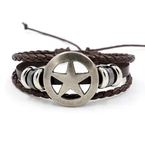 Detail of vintage multilayer brown leather bracelet with star metal charm and beads