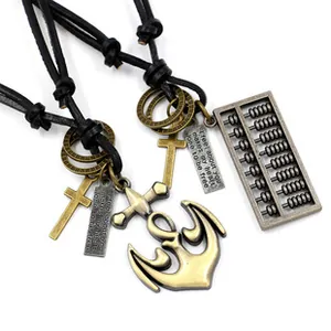 Detailed shot of retro braided leather necklace with bronze anchor and cross pendants