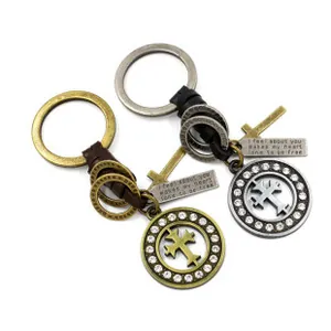 Detail of vintage zinc alloy cross pendants and braided leather keychain for men
