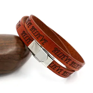 Brown leather wrap bracelet with laser engraved BELIEVE lettering and silver metal buckle