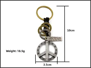Macro view of vintage peace sign keychain with leather cord and size specifications