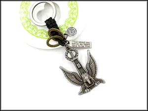 Close-up of vintage eagle pendant with black braided leather strap and bronze metal details