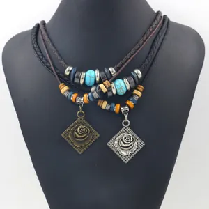 Detail of retro leather necklaces with rose relief charms and turquoise beads