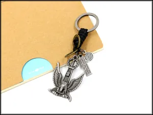 Close-up of eagle pendant on woven leather keychain with engraved inspirational quote