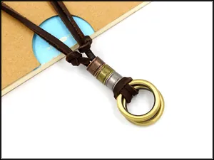 Macro shot of adjustable leather necklace with vintage bronze double rings and metal beads