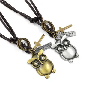Detailed view of vintage owl pendants in gold and silver finish on brown leather cords