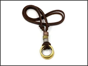 Close-up of vintage bronze double-ring pendant on brown leather cord necklace