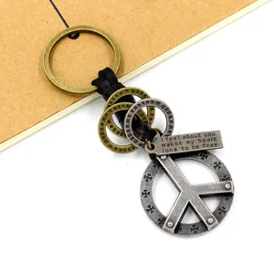 Vintage zinc alloy peace sign keychain with braided leather strap and antique bronze finish