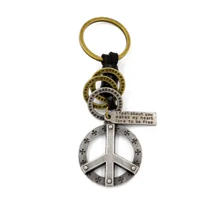 Vintage zinc alloy peace sign keychain with braided leather cord and cross relief charm