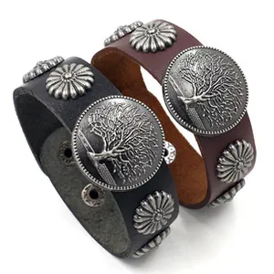 Macro detail of punk leather bracelets featuring Tree of Life metal studs and rivets