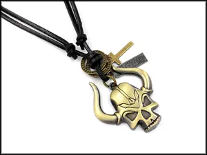 Detail of bronze skull pendant with cross and engraved tag on leather cord necklace