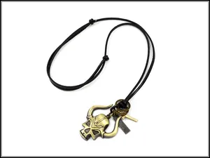 Macro view of punk leather necklace with bronze skull cow head and cross pendants