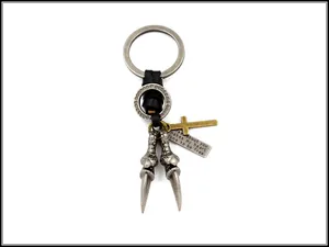 Detail of punk eagle claw keychain with braided leather and engraved metal quote charm