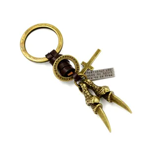 Punk eagle claw keychain with genuine leather wrap and metal cross pendant on white background