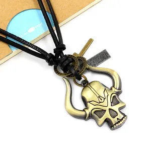 Vintage bull skull pendant on black leather cord necklace with punk style aesthetic