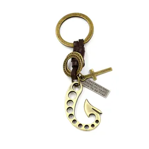 Vintage bronze fish hook keychain with brown leather braid and cross pendant charms