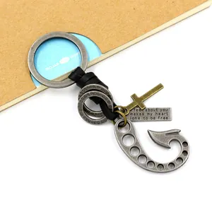 Vintage fishhook keychain with leather braid, cross pendant, and engraved metal tag