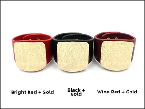 Detailed view of textured leather cuff bracelets in red, black and wine with gold metal