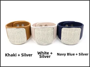 Detail of wide PU leather bracelets with textured silver metal plates and snap buttons