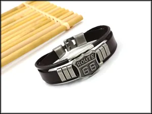 Detailed macro view of Route 66 vintage shield on dark brown leather punk bracelet