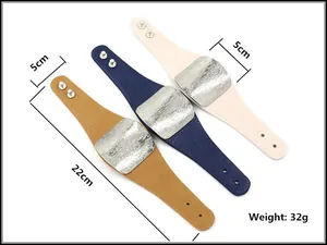 Detail showing 5cm wide leather bangles with hammered metal plates and snap buttons