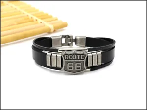 Detail of multi-layer leather bracelet with vintage Route 66 shield and silver buckles